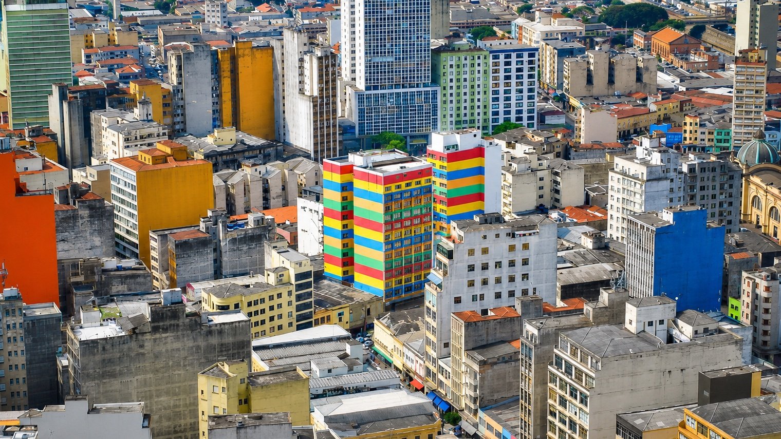Aerial view of a dense, colorful South American city skyline